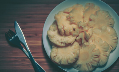 Pineapple with slices on white background