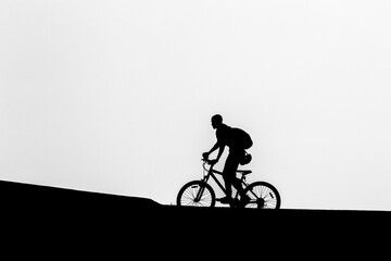 Obraz premium silhouette of a cyclist on the road