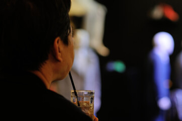 An Unidentified Person Drinking a Refreshment in a Show