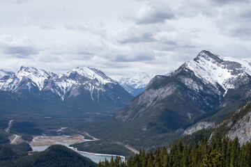 View on snowy mountain peaks and forest valley, shot in Canadian Rockies at Prairie View Trail, Kananaskis, Alberta, Canada