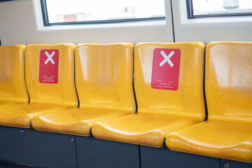Yellow seat in public train for social distancing, new normal and life after covid-19 pandemic
