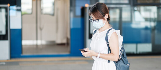 young Asian girl wearing Surgical face mask protect coronavirus inflection, Happy tourist woman...