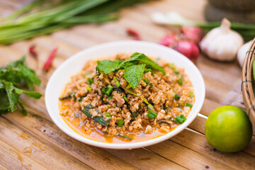 spicy minced meat salad on the wooden table,Thai food.