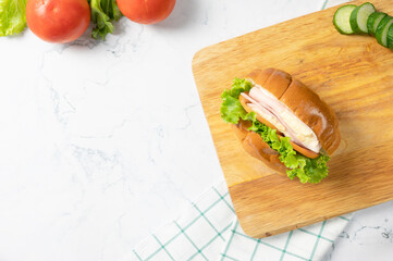 Delicious sandwich with fresh salad, Ham and cheese on white background. Top view with copy space. Flat lay.