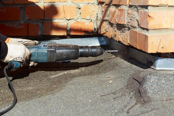 Worker with pneumatic hammer drill