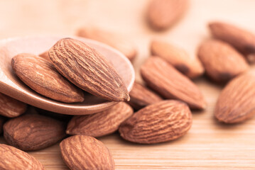 Close up view of almond seed. Almond seeds placed on a wooden floor