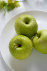 Wet fresh green apples on a table. The concept of organic and healthy food