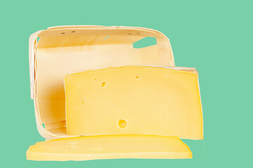 Cheese with packaging close-up on a colored background.