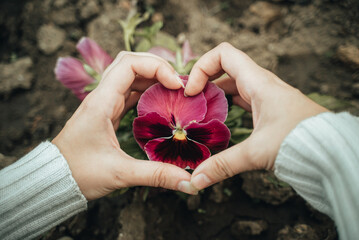 The girl holds flowers in her hands. Growing flowers in the garden. 
Save the planet. Ecology problem poster