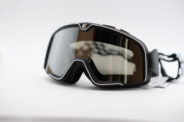 A pair of used motorcycle motocross goggles isolated on white