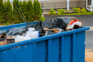 Construction trash dumpsters in an metal container, home house renovation.