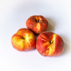 Three orange ripe fig peaches on the white background