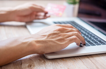 man holding credit card and using laptop via web, business freelancer working at home office. business, lifestyle, technology, ecommerce, digital banking, online payment and shopping concepts