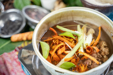 ginger, lemongrass, lime leaves and secang wood shavings on a green leaf tray the raw material of jamu empon-empon