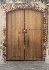 Fototapeta na wymiar Cafe brown colonial gate with vaulted arch