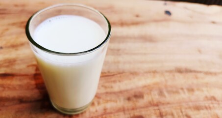 Single milk filled glass on the table