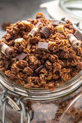 Jar of muesli with dark and milk cocolate pieces - closeup