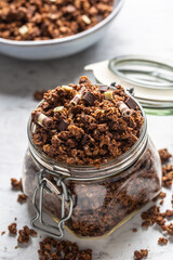 Jar of muesli with dark and milk cocolate pieces - closeup