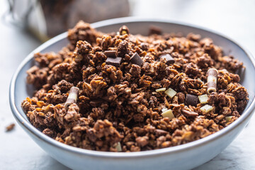 Jar of muesli with dark and milk cocolate pieces - closeup