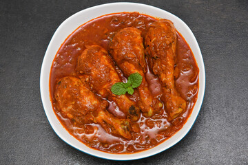 Top view Butter chicken or Murgh Makhani curry roast or Vindaloo hot and spicy gravy dish in Dhaba Punjab, India. North Indian non-vegetarian cuisine Garam Masala. Malabar Chicken curry tikka massala.
