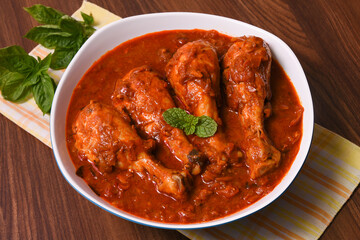 Top view Butter chicken or Murgh Makhani curry roast or Vindaloo hot and spicy gravy dish in Dhaba Punjab, India. North Indian non-vegetarian cuisine Garam Masala. Malabar Chicken curry tikka massala.