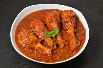 Top view Butter chicken or Murgh Makhani curry roast or Vindaloo hot and spicy gravy dish in Dhaba Punjab, India. North Indian non-vegetarian cuisine Garam Masala. Malabar Chicken curry tikka massala.