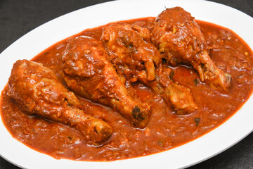 Top view Butter chicken or Murgh Makhani curry roast or Vindaloo hot and spicy gravy dish in Dhaba Punjab, India. North Indian non-vegetarian cuisine Garam Masala. Malabar Chicken curry tikka massala.