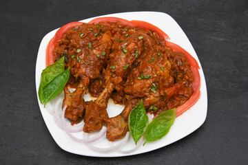 Top view Butter chicken or Murgh Makhani curry roast or Vindaloo hot and spicy gravy dish in Dhaba Punjab, India. North Indian non-vegetarian cuisine Garam Masala. Malabar Chicken curry tikka massala.