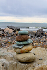 Fototapeta na wymiar Pile of stones at Hokitika beach on a cloudy day, south island, New Zealand