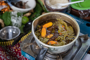 raw material for traditional herbal medicine with boiled turmeric rhizome, tamarind and tamarind leaves in a pan, the concept of making traditional herbal medicine