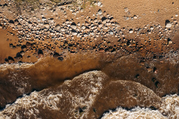 Waves hitting rocky beach in Latvia Veczemju beach from above