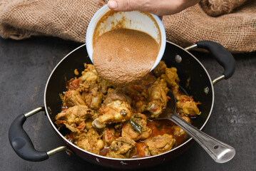 Chettinad chicken curry is a hot and spicy dish Tamil Nadu, South India. Gravy prepared from roast and ground Indian spices,coconut or garam masala for meat / non-vegetarian recipe/ cuisine.
