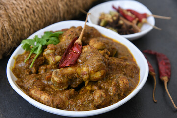 Chettinad chicken curry is a hot and spicy dish Tamil Nadu, South India. Gravy prepared from roast and ground Indian spices,coconut or garam masala for meat / non-vegetarian recipe/ cuisine.