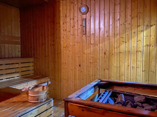 Relax sauna room with wood, heater and stones