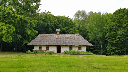 Fototapeta na wymiar The old house of peasants in the museum Pirogovo. National Museum of Folk Architecture and Everyday Life of Traditional Folklore Houses of Different Regions of Ukraine