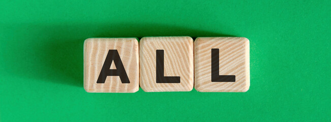 ALL text concept on wooden cubes on a green background