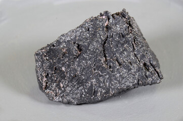 Piece of Neodymium (Nd). The piece is covered with a thin layer of oil to prevent air contact