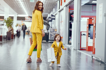 Beautiful girl in a shopping center. Lady with shopping bags. Mother with daughter in stylish clothes