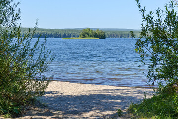 forest lake bushes and an island in the distanse