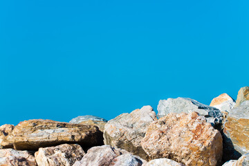 Dam with stone blocks against a blue sky - image with copy space
