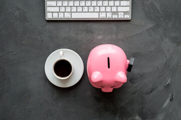 Earn money online. Concept with piggy bank on gray desktop. Top view copy space