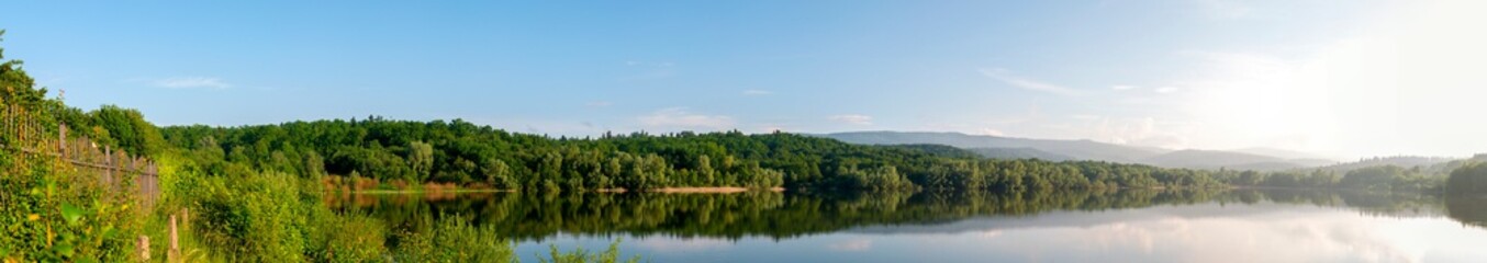 colorful panorama of autumn lake on a bright sunny day