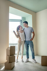 Fototapeta na wymiar Young couple hugging and feeling happy after moving to a new apartment