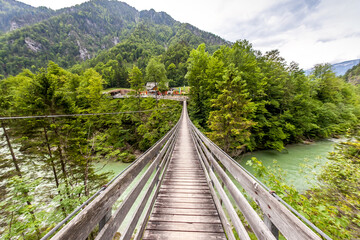 Fototapeta premium Bridge over the mountain rivers in the Austrian Alps.