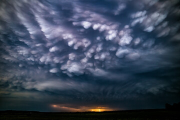 Fototapeta na wymiar Late evening mammatus clouds with lightning