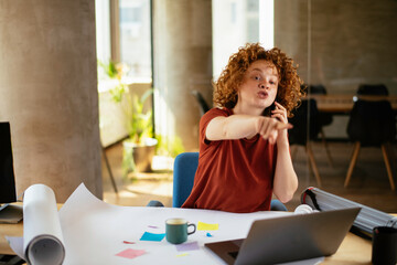 Girl at work, using her phone. Female manager at the office desk.	