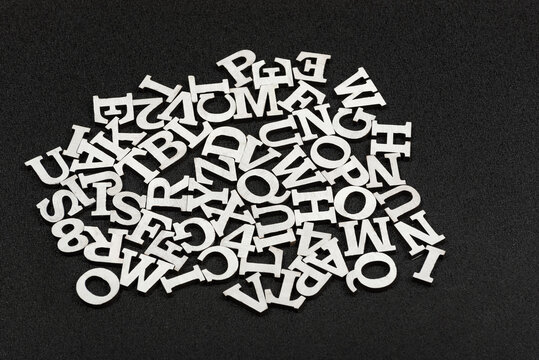 Letters of Latin alphabet arranged in chaotic order. Black background.