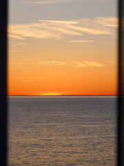 Beautiful sunset or sunrise or twilight at sea seen from modern cruiseship or cruise ship travel...