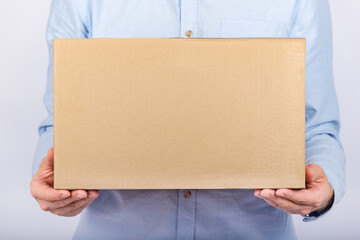 Man holding cardboard box. Front view. Parcel delivery home. Express delivery.