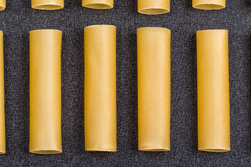 Few cannelloni on grey background close up. Pasta background. Italian national cuisine.